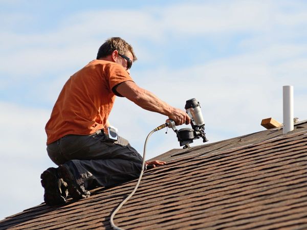 An image of a man working on a roof.