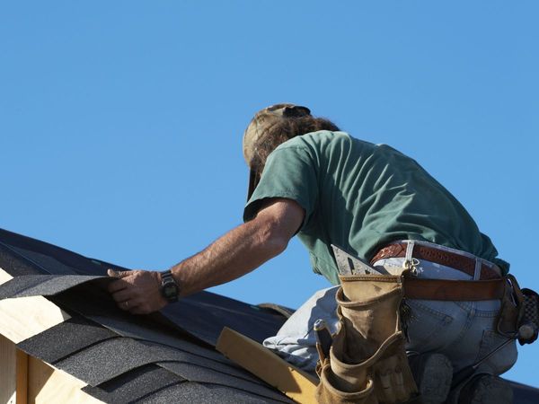 An image of a man working on a roof.