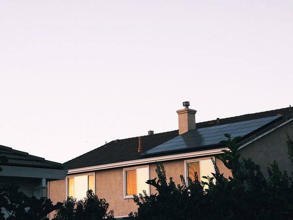 Solar panels on the side of a home at sunset