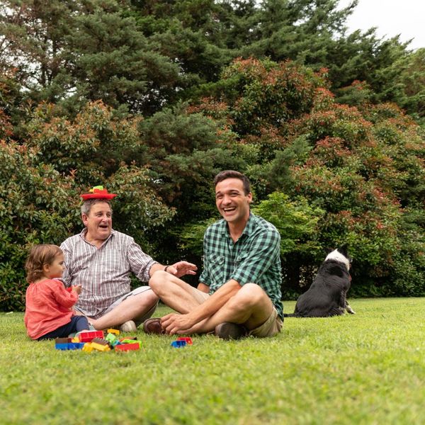 family members enjoying time outside with a dog