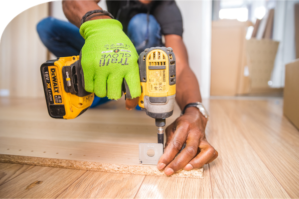 a carpenter working with a drill