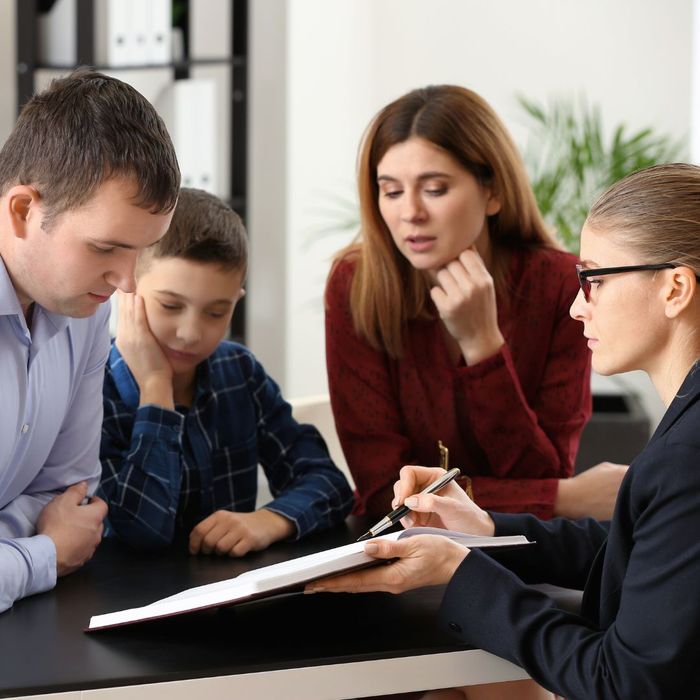 a family looking at paperwork with a lawyer
