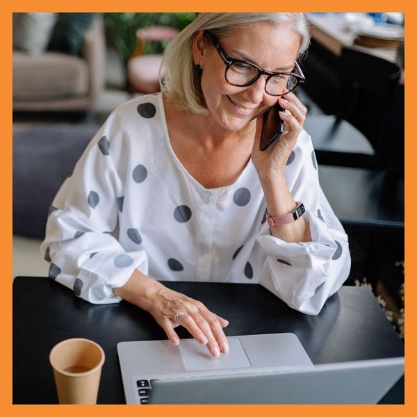 woman using laptop on phone