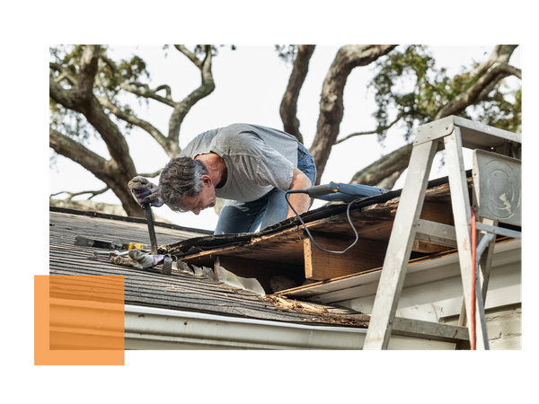 Image of man looking at a damaged roof