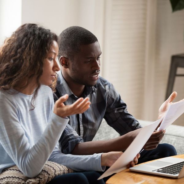 man and woman looking at insurance claim paperwork