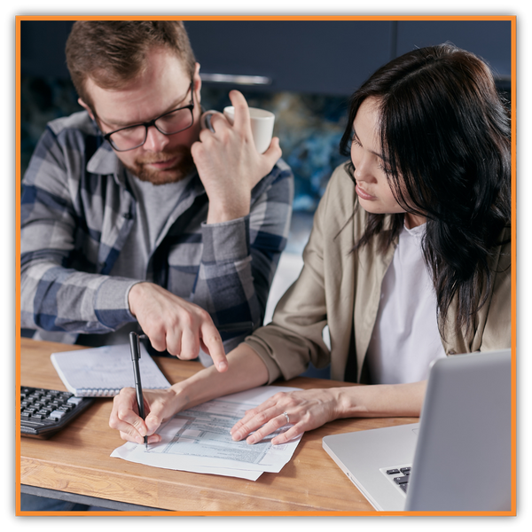 Couple Looking Over Energy Bills The Benefits of Proper Roof Ventilation2.png