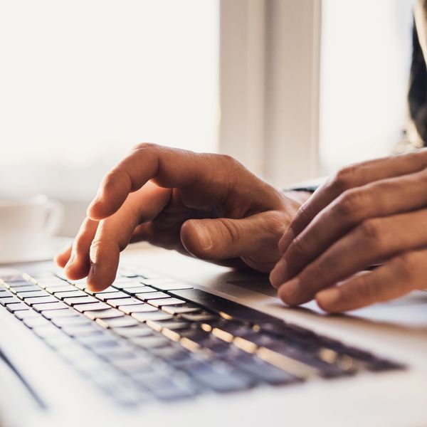 hands typing on laptop