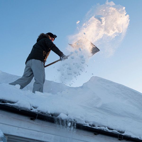 person removing snow from their roof
