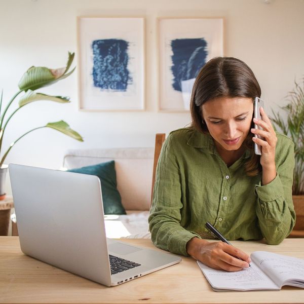 woman on the phone taking notes