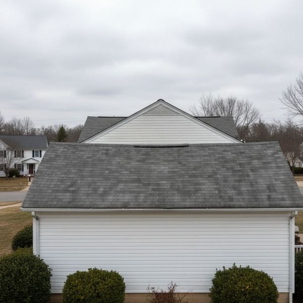 A profile view of a house roof with a visible and concerning sag in the center ridgeline.