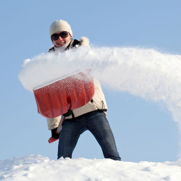 person removing snow from their roof