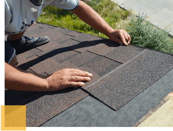 Man replacing roofing tile.