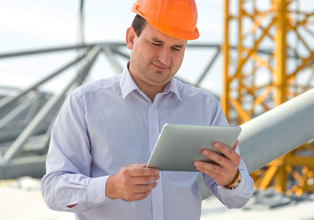 Smile contractor looking at a tablet