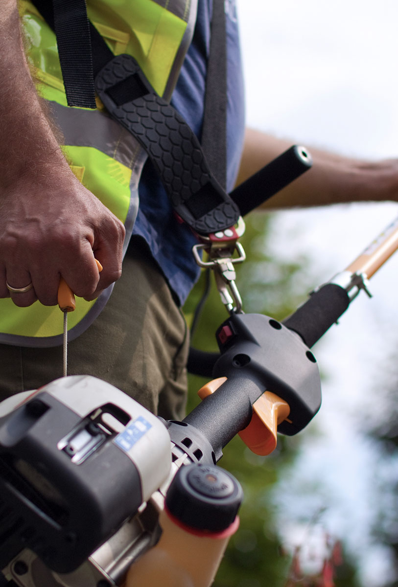 Man holding a weedwacker 