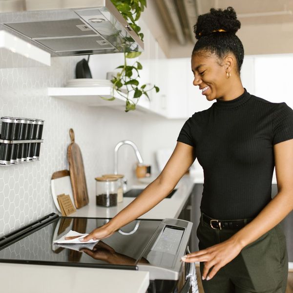 Woman cleaning her kitchen. Woman cleaning her kitchen.
