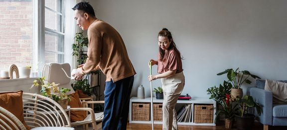 Couple cleaning their house.