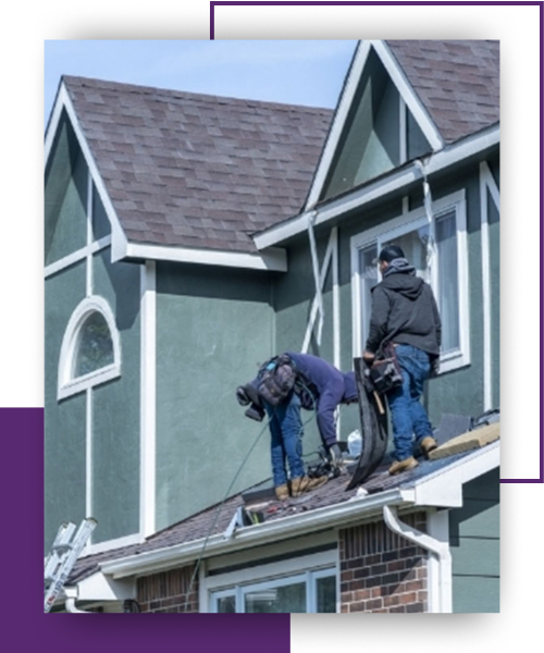 Two roofers working on a roof