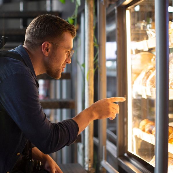 image of a man using a vending machine