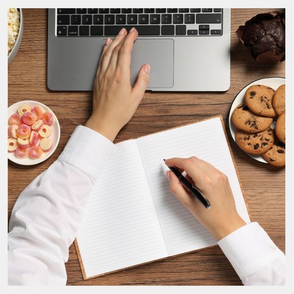 A person working and eating sncaks