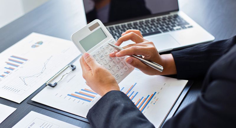 accountant typing on calculator