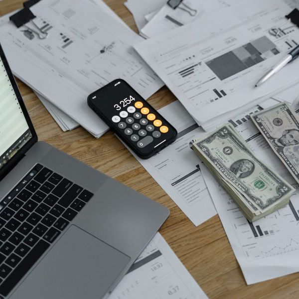 payroll paperwork and cash on desk 