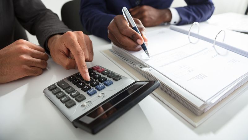 two professional people working on business taxes