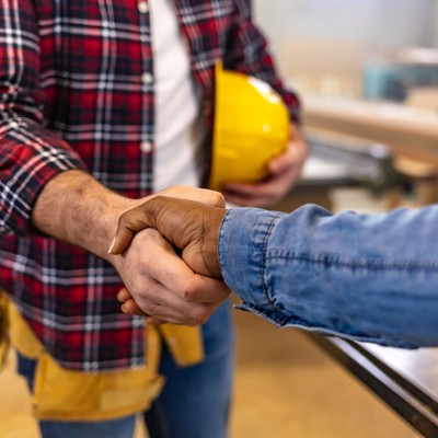 Contractor shaking hands with client