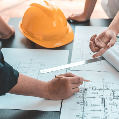 contractor reviewing blueprints on a job site