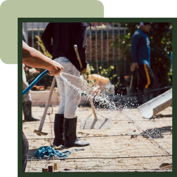 Team of workers setting foundation for a home