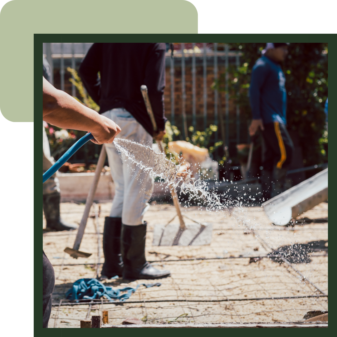 Team of workers setting foundation for a home