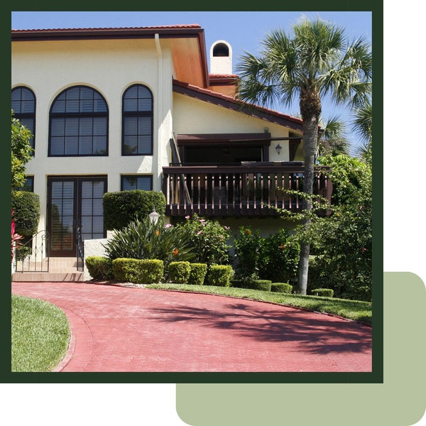Outside of a home with a brick driveway