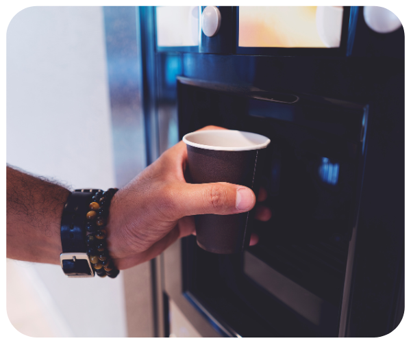 Person getting coffee from a machine