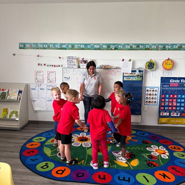 teacher dancing with her schoolkids in a circle Preparing for Fall1.jpg