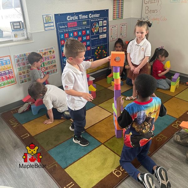 children in a preschool setting, possibly engaged in block building, floor play, or other activities that combine imaginative construction with physical movement, representing both creativity and gross motor skill development. The Importance of Early Childhood Education in Shaping New Learners 4.jpg