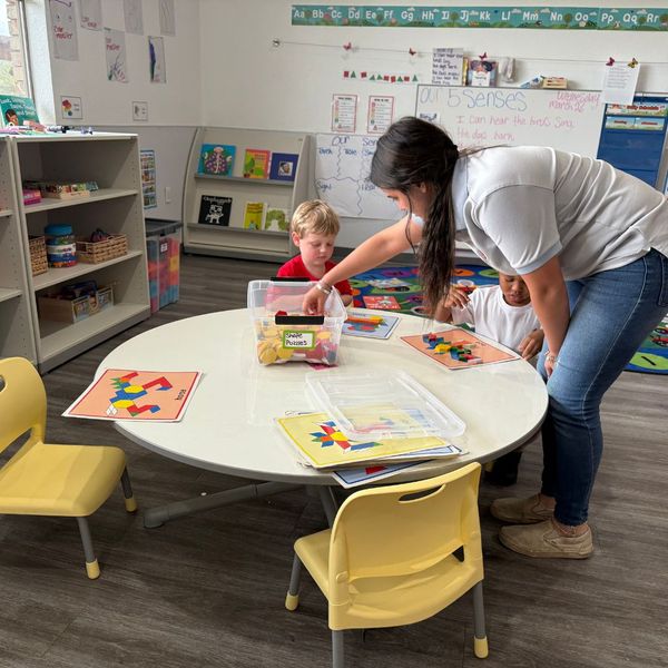 teacher working with kids at a table Preparing for Fall4.jpg