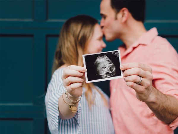 couple holding sonogram picture