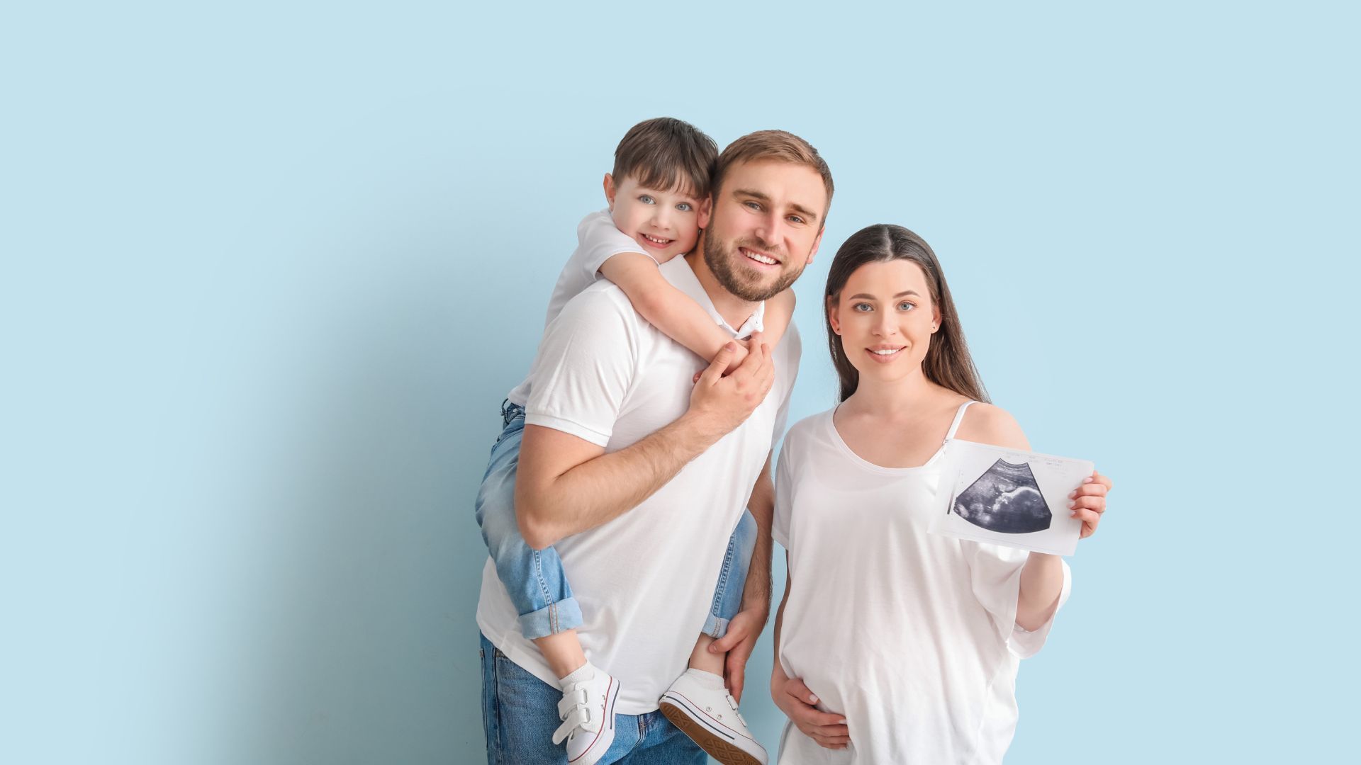 family holding baby ultrasound photo