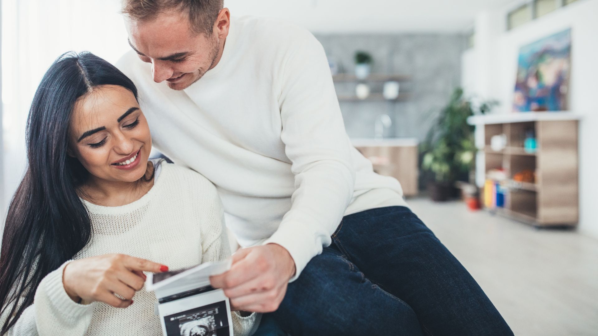 expectant couple looking at ultrasound images
