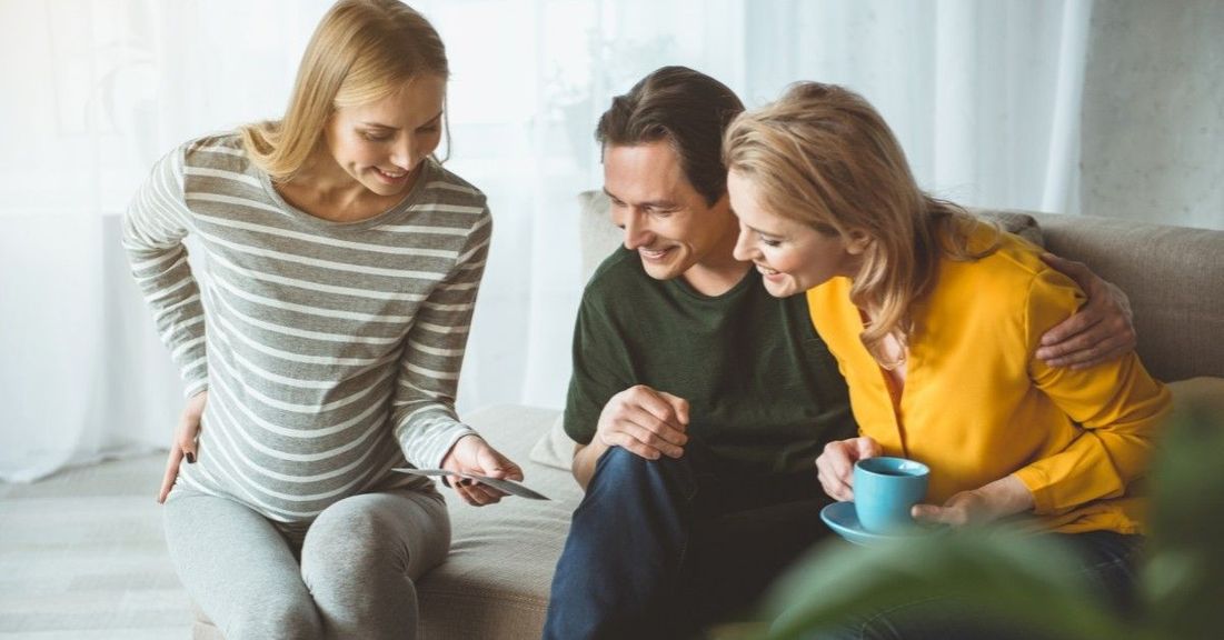 Woman showing ultrasound photos