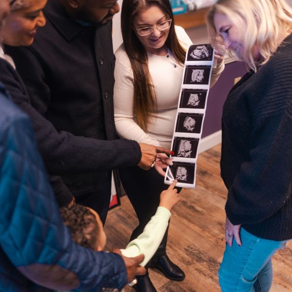 family looking at baby ultrasound