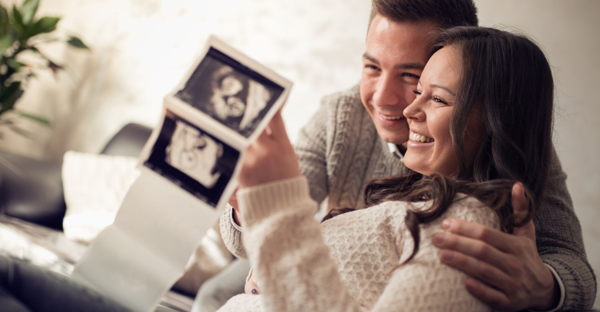 Happy parents look at ultrasound images