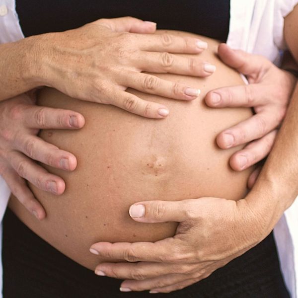 pregnant woman holding stomach pregnant woman holding stomach