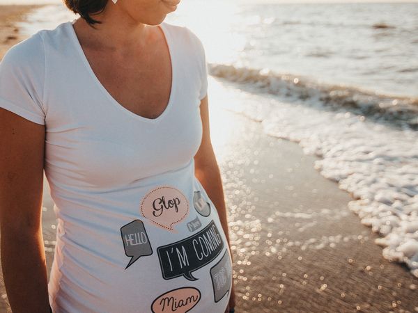 image of pregnant woman on beach