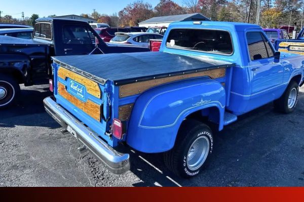 a blue vintage truck with the bed covered