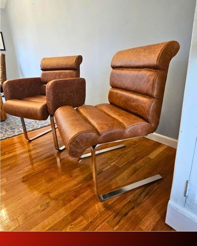 a pair of upholstered leather chairs