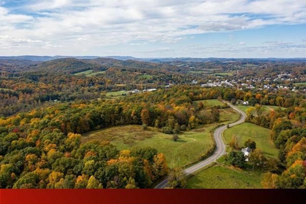 a winding road through the autumn landscape of the tri-state area