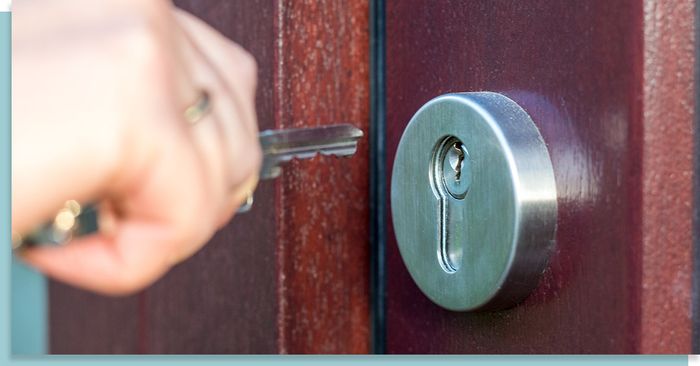 person about to insert a key into a lock