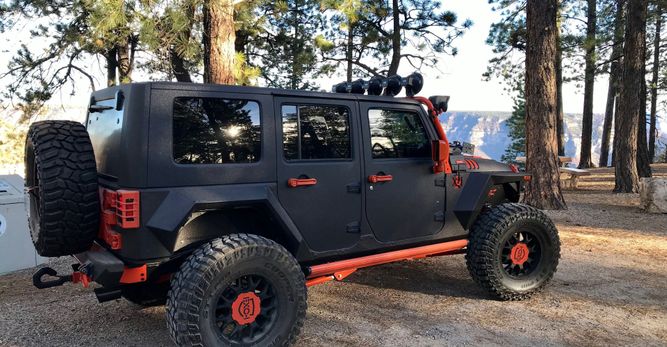 Black and orange Jeep with tinted windows