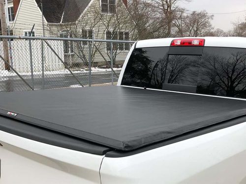 A white truck with a tonneau cover installed