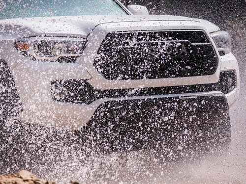 photo of truck driving through water